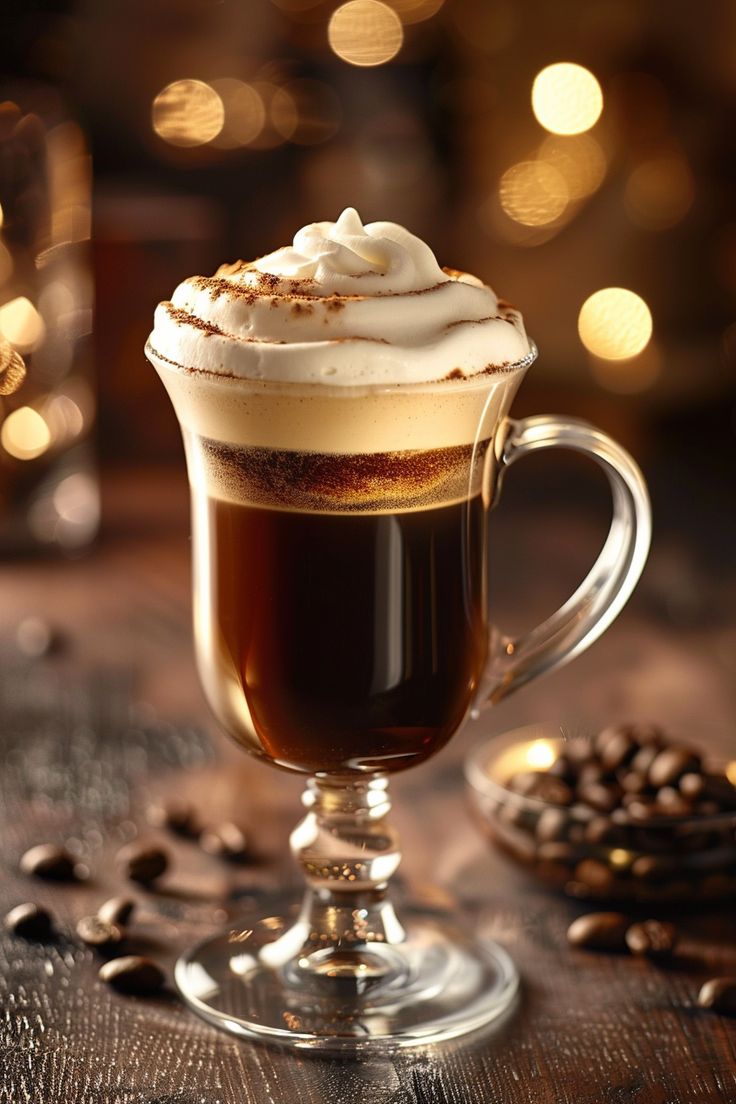 Irish coffee in clear glass mug with thick cream layer on top
