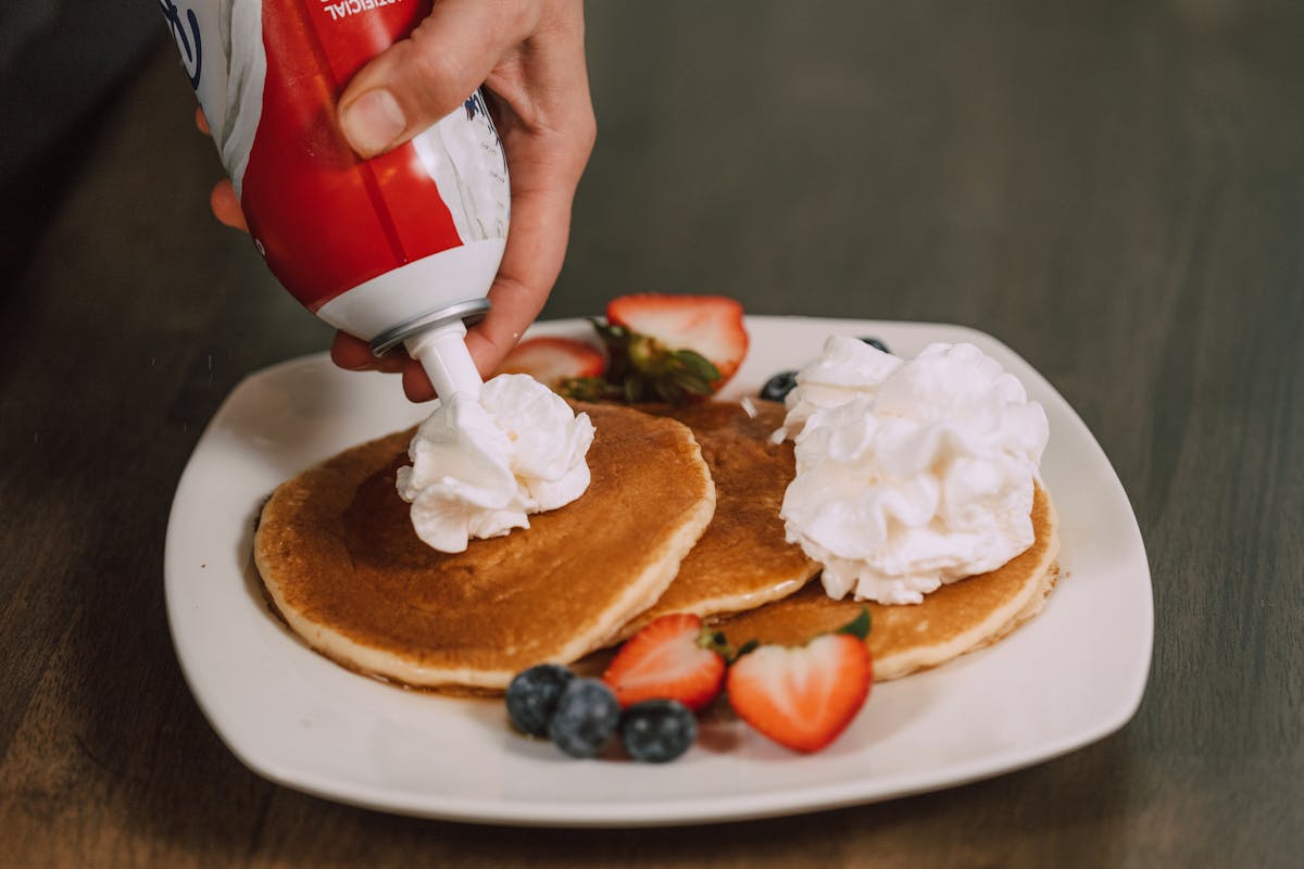 Restaurant-quality pancakes topped with fresh whipped cream