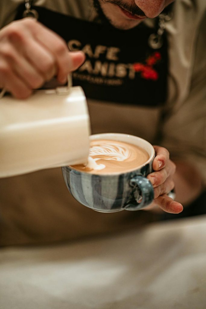 Barista creating latte art in coffee shop