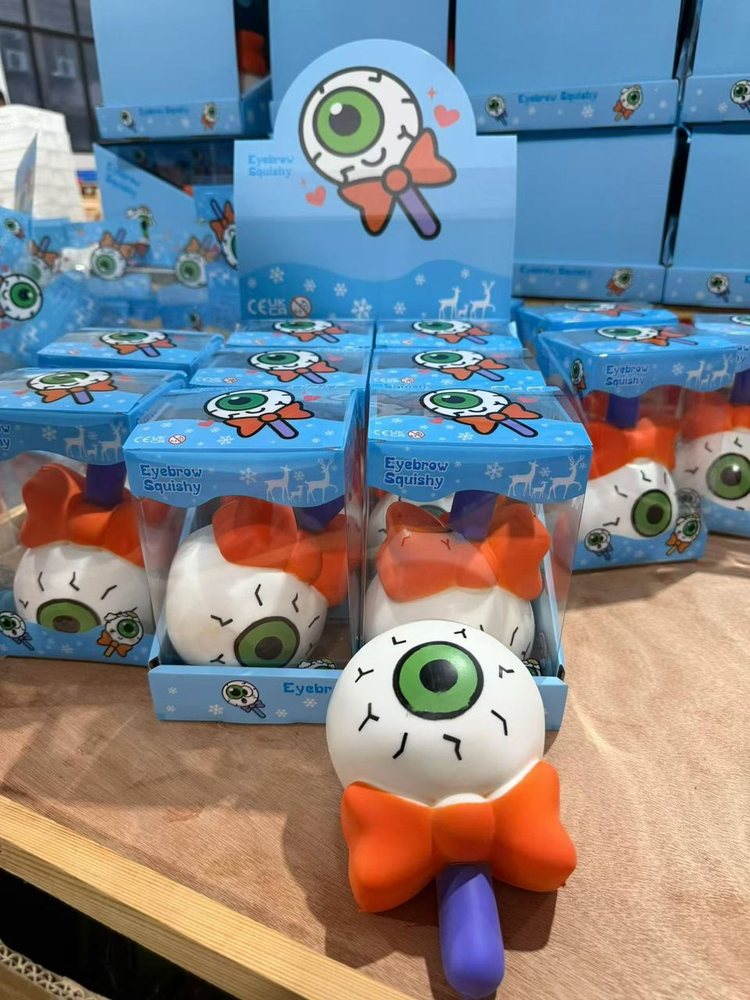 Wholesale Squishy & Fidget Toys | Bulk Squishies, Mochi & Stress Keyboards 18 Wholesale Halloween eyeball squishy toys on a display stand